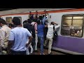 Heavily overcrowded fast local train @ Thane station, Mumbai