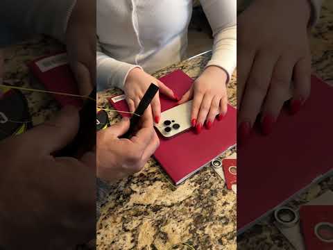 Part of a video titled How to remove an iPhone camera lens protector ... - YouTube