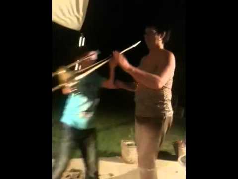 Drunk woman playing trombone