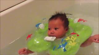Baby using the swim ring in bath tub and hot tub