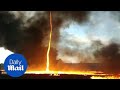 Incredible footage of fire tornado during massive factory blaze
