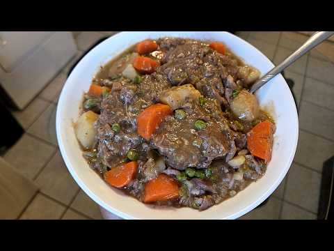 Homemade Pork Neck bone stew | Neck bones potatoes carrots and peas in a seasoned pork broth