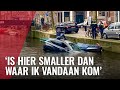 Automobilist op dak van zinkende auto in Lijnbaansgracht