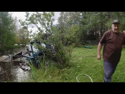 Traktori sukeltaa järveen.