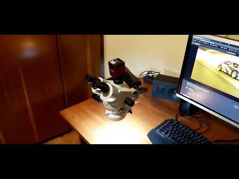 microscope arm from an articulated monitor arm