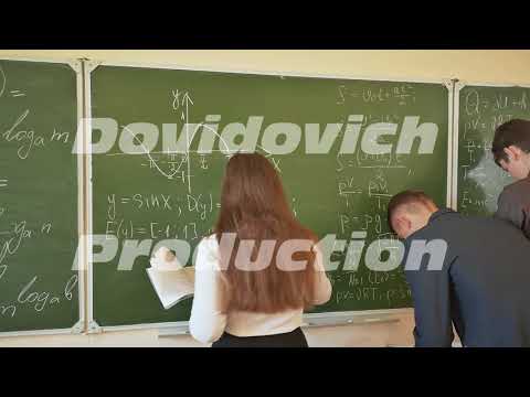 Three students write on the blackboard mathematical formulas in the classroom. Russian school