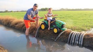 Playing in the mud and watering hay with tractors | Tractors for kids in the mud