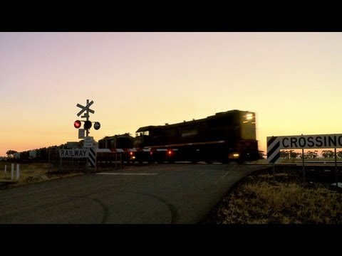 Level Crossing - Freight Train and Passenger Train at Sunset - PoathTV Australian Train Videos