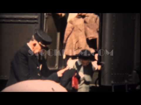 1937: Train conductor helping mother and daughter exit railroad train.  TRYON, NC