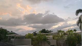 Timelapse of clouds flying in the sky above hotel in tropical country with warm climate