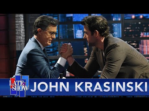 John Krasinski And Stephen Colbert Go Mano A Mano In An Arm Wrestle, Again