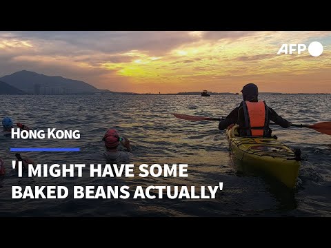 Video | Swimmers battle cramp, delirium to conquer Hong Kong's largest island | AFP