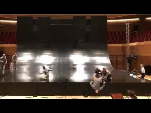 Catching one of the dancers before he falls into the orchestra pit by Yoann Bourgeois