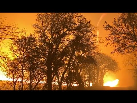 Woman's home burns in massive Texas wildfires