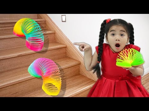 Suri Playing with Colorful Rainbow Slinky Toy