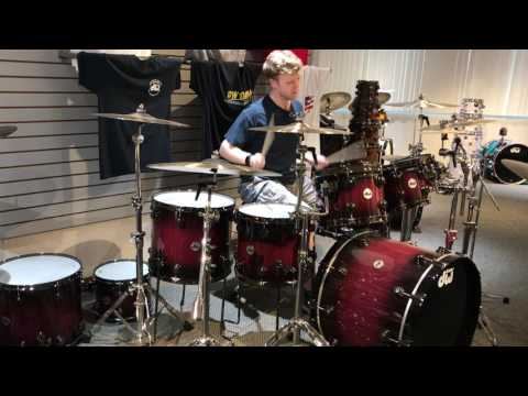 Playing DW Purpleheart Drum set in Showroom