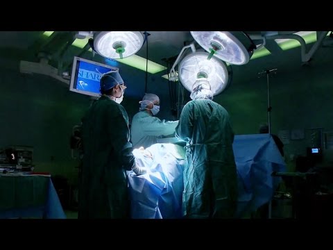 Doctors in an operating room around a patient