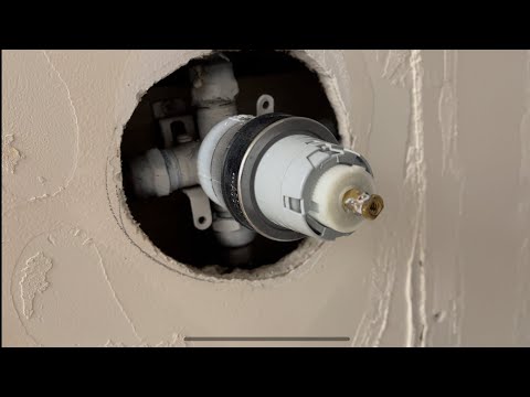 Part of a video titled Cold shower? Adjust the anti scalding valve - YouTube