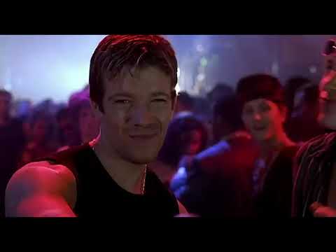 Final trailer frame of a spotlighted soloist at the mic foreshadowing the film’s concert climax