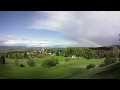 Passing thunderstorm timelapse with rainbow