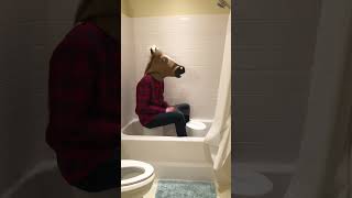 Man-horse plays &quot;Paranoid&quot; by Black Sabbath on a bucket in the bathtub