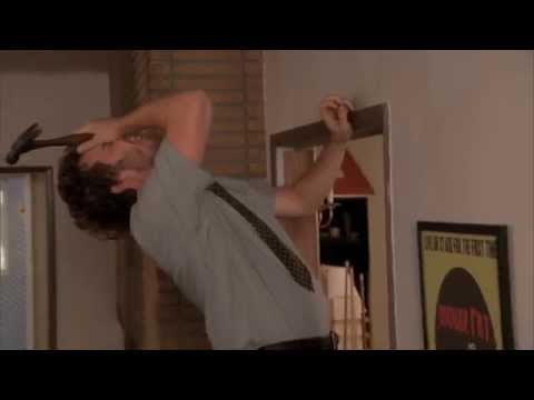 Andy Dwyer sneezes while hanging his gold record on the wall