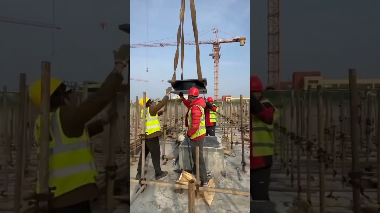 .Workers in safety vests and helmets coordinating a complex high-rise construction process.