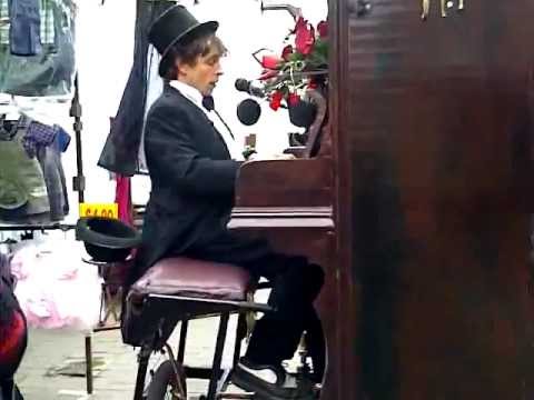 Cycling Pianist with his Piano in Walthamstow Market