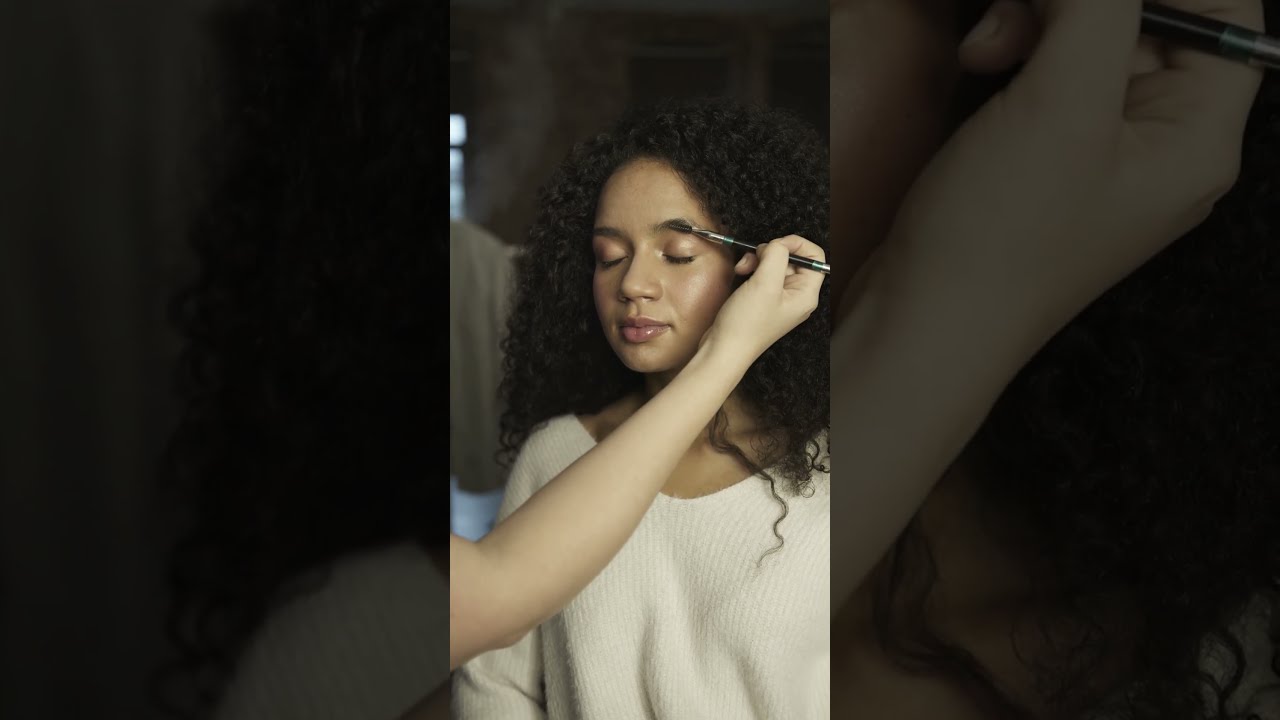 A Woman Model Having An Eye Brow Makeup Backstage