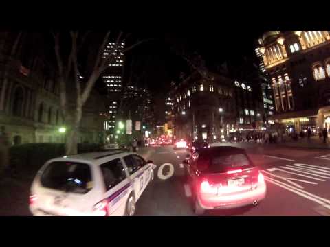 Taxi pushes cyclist out of the way