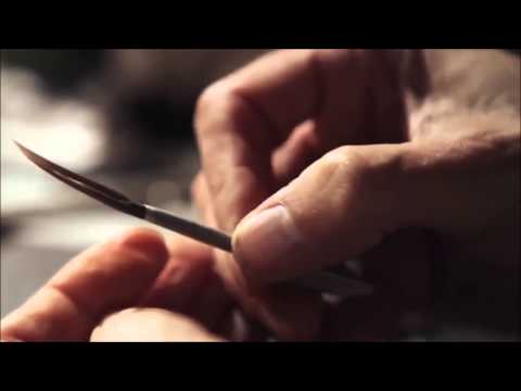 Making a paintbrush from a feather.