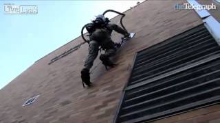 Students use vacuum cleaner to climb brick wall
