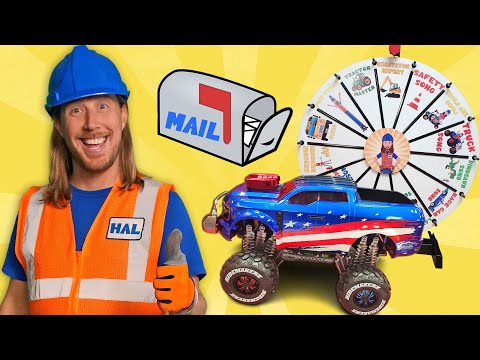 Smiling man in a blue hard hat and orange safety vest beside a red-white-blue toy truck and a prize wheel.
