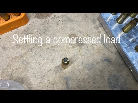 Settling powder in a compressed load