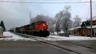 preview picture of video 'CN train at Perry Michigan starts up after waiting for a better signal.  Third unit is Rare'