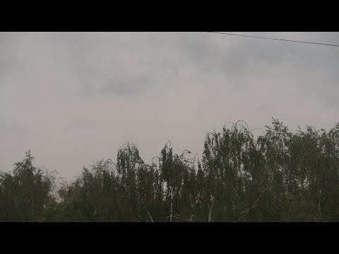 The movement of storm clouds and the onset of darkness