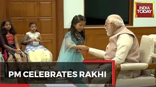PM Modi Celebrates Raksha Bandhan Video | Daughters Of PMO Staff Tie Rakhi To PM Modi; WATCH