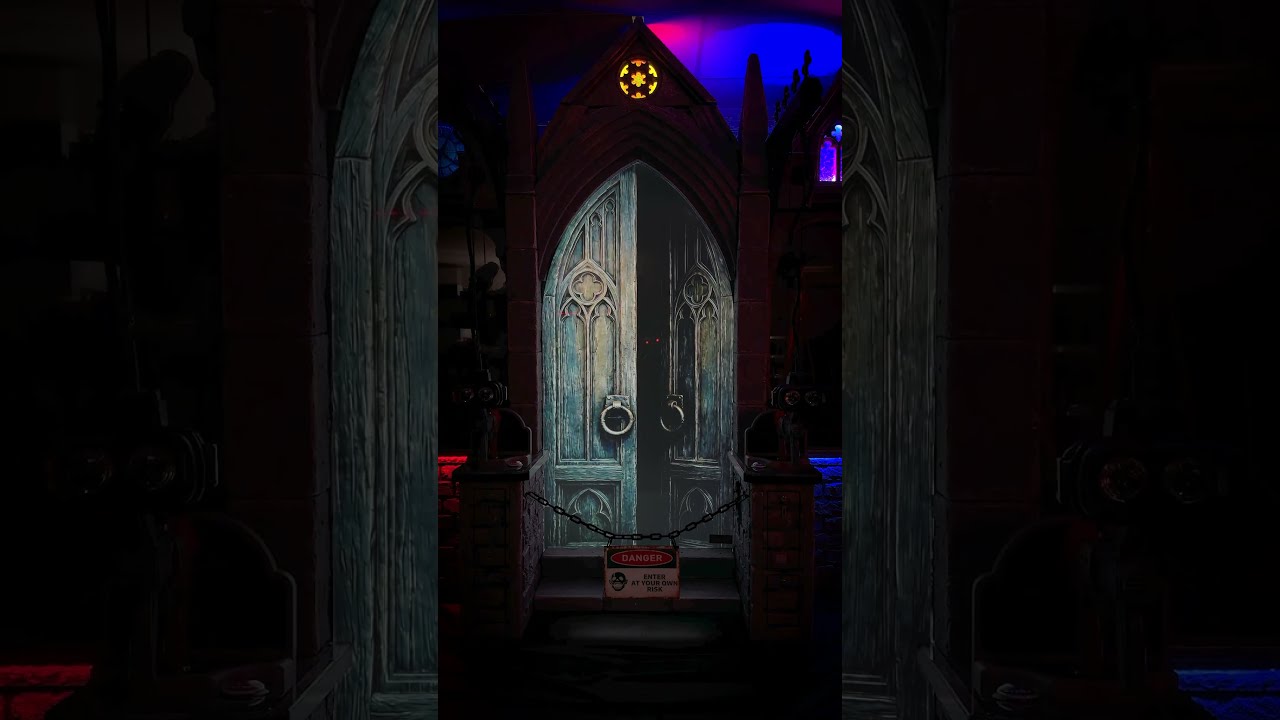 Thumbnail for the Sega Amusements teaser Something is Reawakening, showing a chained gothic double door with a danger sign hung across it