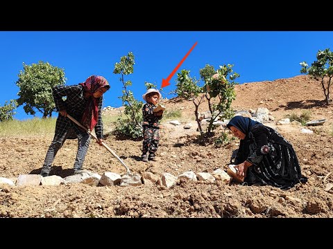 Single mother's resistance: preparing stones for the garden area next to the cave