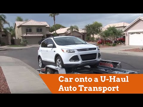 Part of a video titled How to Load a Car onto a U-Haul Auto Transport - YouTube
