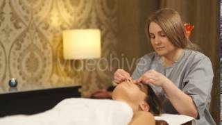 Beautiful Brunette Doing a Facial Massage in a Spa Center | Stock Footage - Videohive