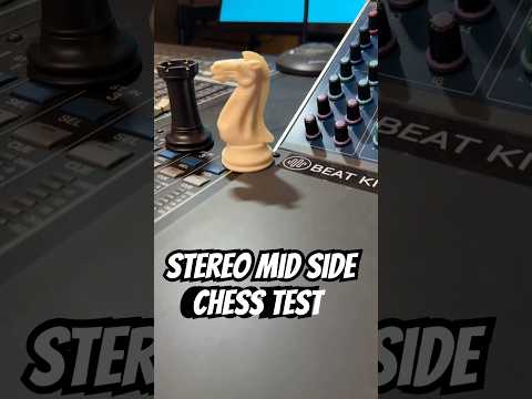 Chess pieces and audio cables on a chessboard atop a piano
