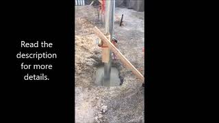 Setting metal poles in concrete.