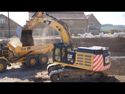 Cat 352F Loading New 730 Trucks