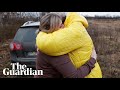 Ukrainian mother hugs her children brought to safety by a stranger