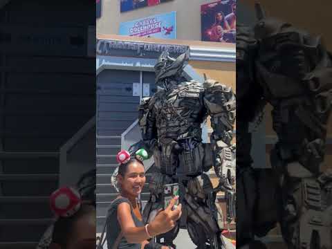 Megatron is wailing while woman is trying to take a photo with him!