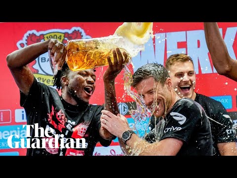 Bayer Leverkusen players shower Xabi Alonso in beer during press conference