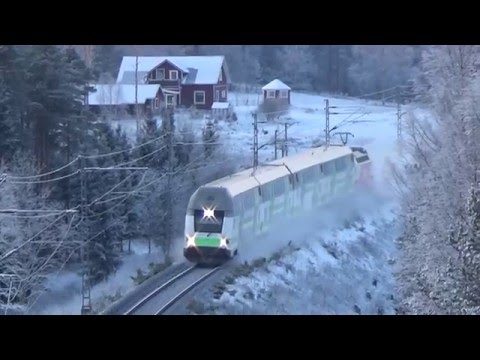 Finnish InterCity train 960 and Pendolino 955 passing a railway tunnel
