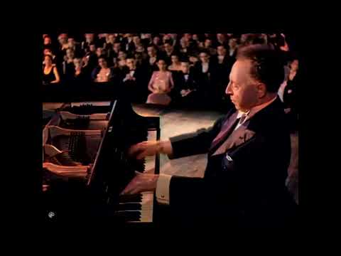 Artur Rubinstein plays "Polonaise" at Carnegie Hall, in 1947. AI Colorize.