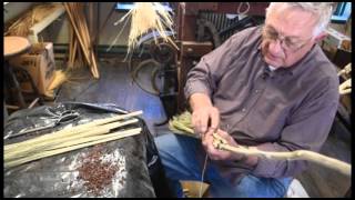 Making a broom by hand with broom corn.